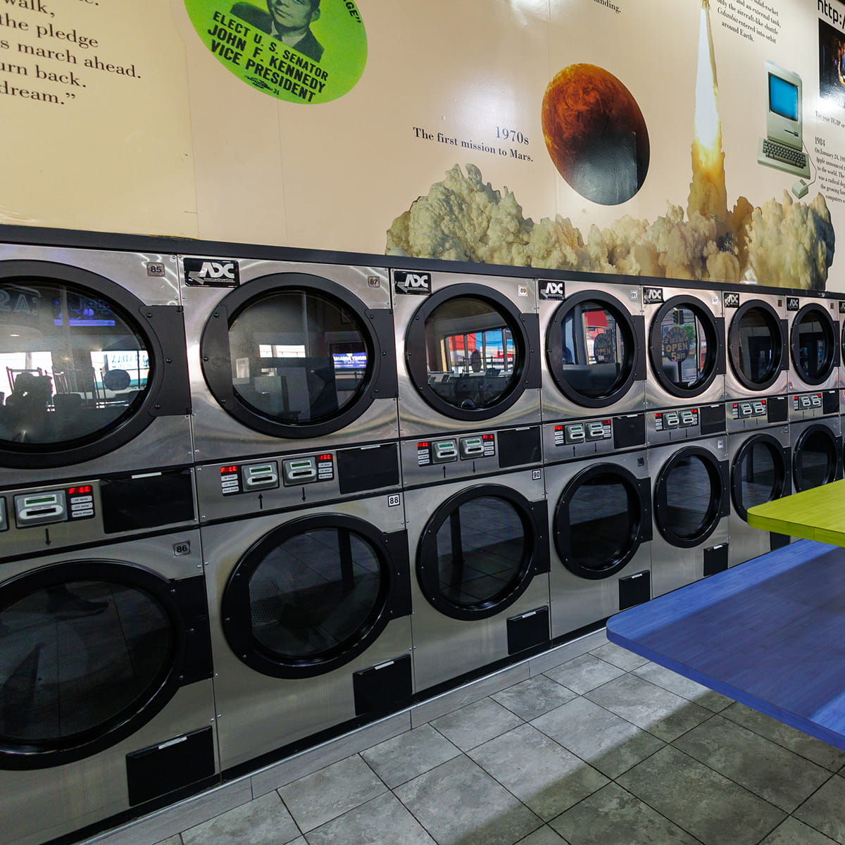 Interior of Showcase Laundromat in Elizabeth, NJ, with rows of washers and dryers