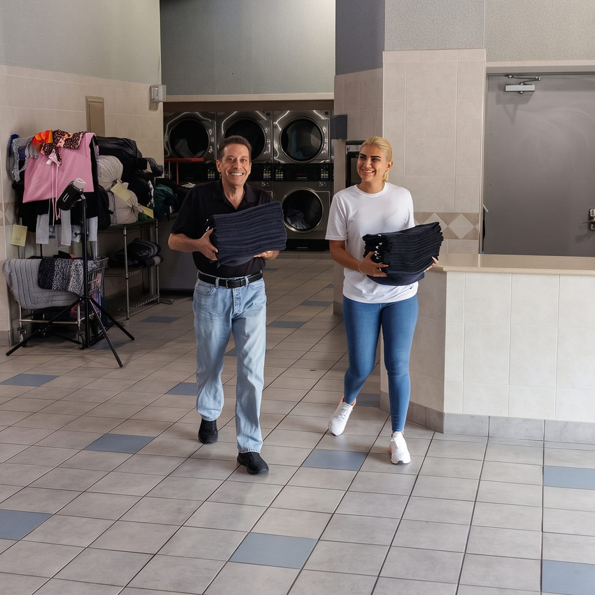 Customers and staff doing laundry at Showcase Laundromat in Perth Amboy, NJ