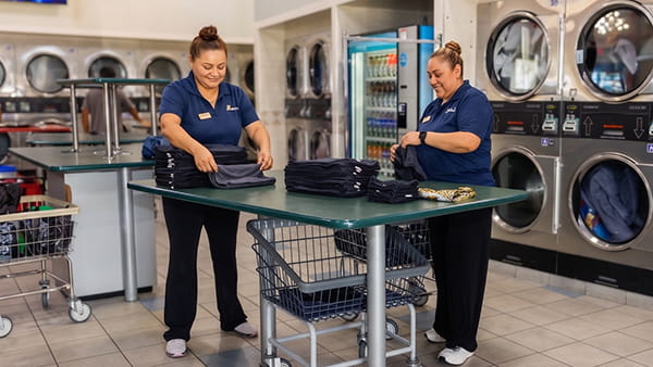 Showcase Laundromat employees providing professional wash and fold laundry service in New Jersey